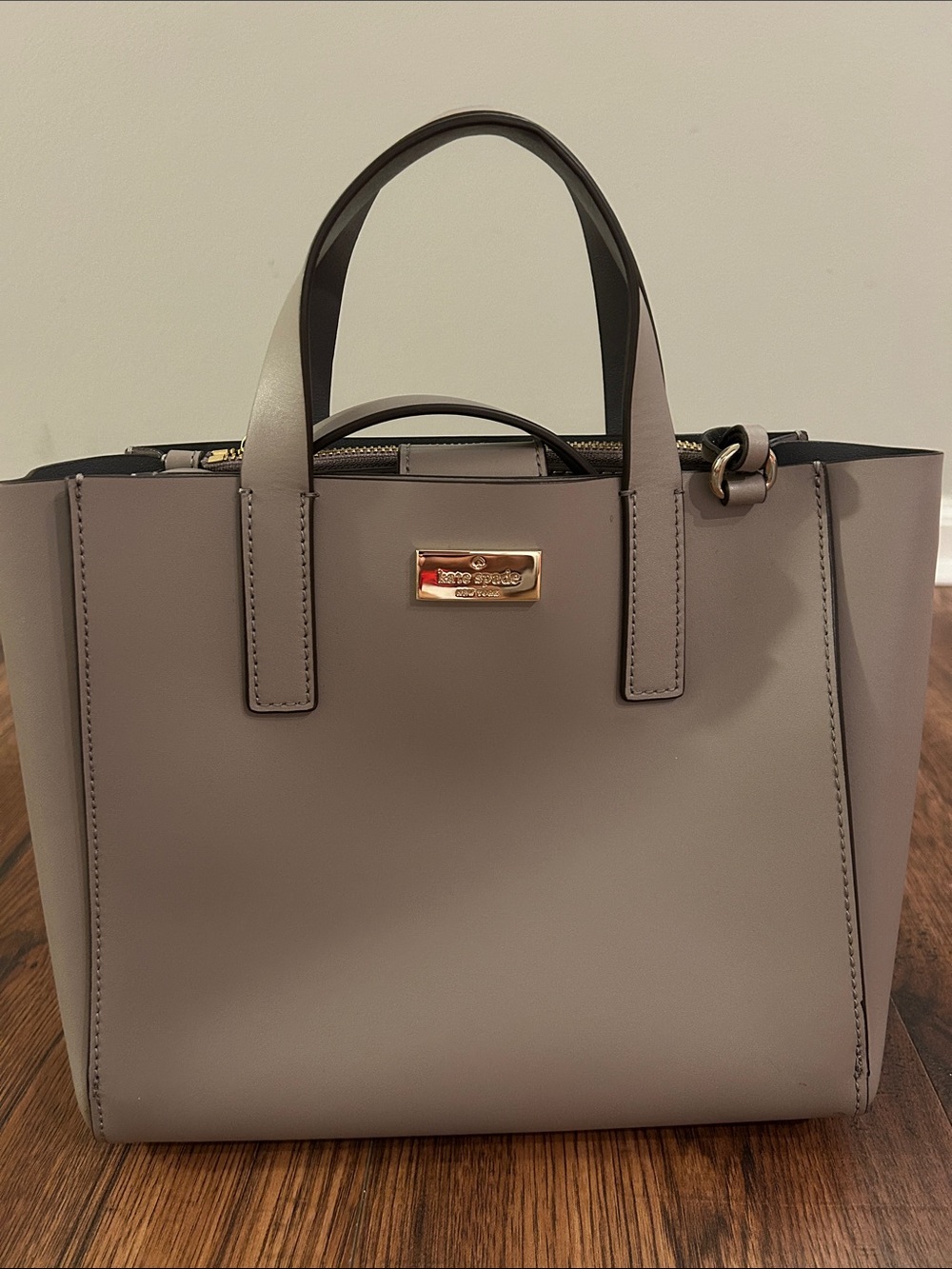 kate spade taupe leather tote with gold-tone plaque
